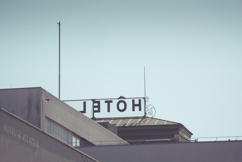 a hotel sign over an old building in salzburg, salzburg hotel 4k