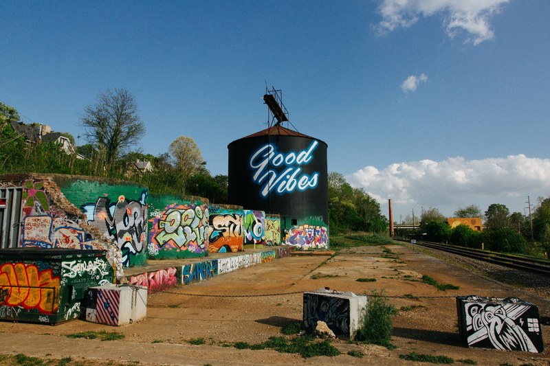 long shot of good vibes text street art on cylindrical structure at river arts district, good vibes 4k