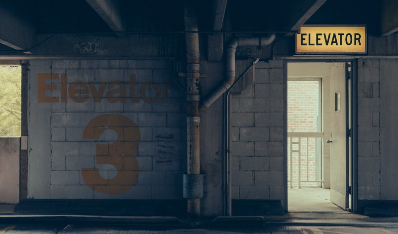 a door leading to an elevator in an old building in jackson, half way 4k