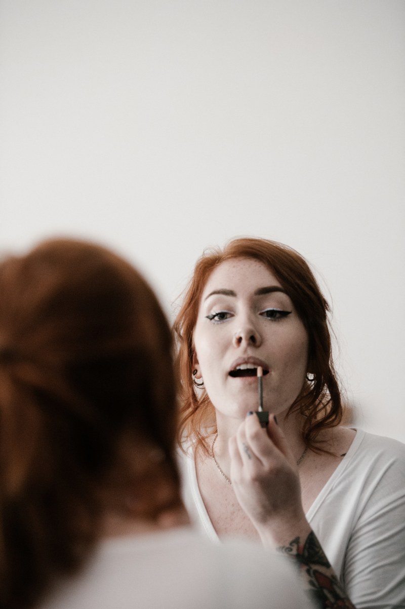 woman applying lipstick make up 4k
