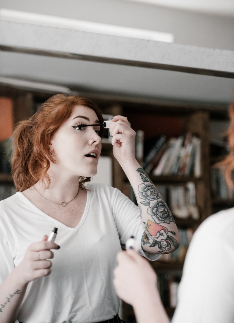 woman applying mascara make up 4k