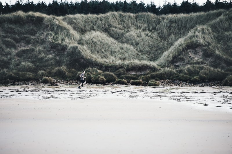 man running runner on beach 4k