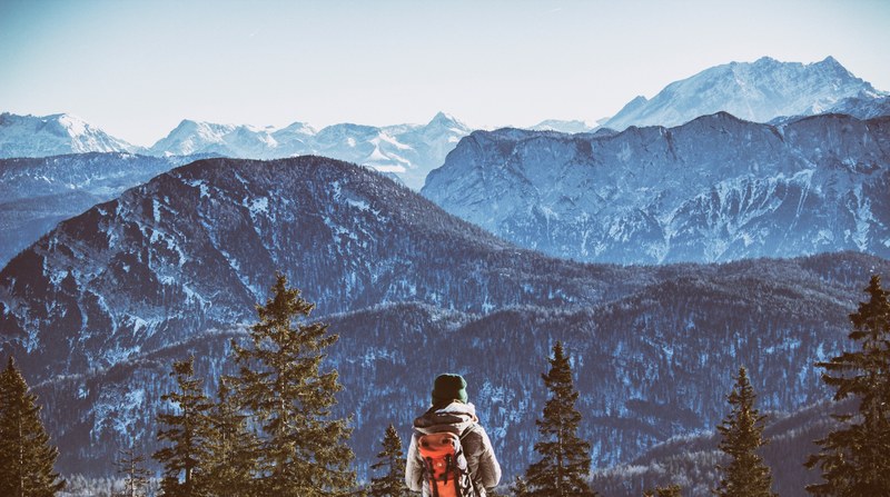 a man with a backpack on stares into the chiemgau alps, just me pretending to be one of those trees_ 4k