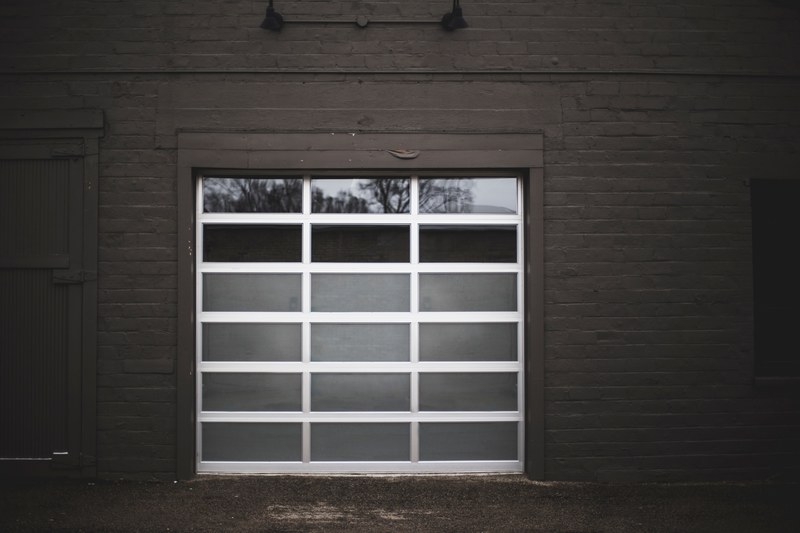 the garage door of a building made from glass with dark brick walls in grand rapids, _garage door dark walls 4k