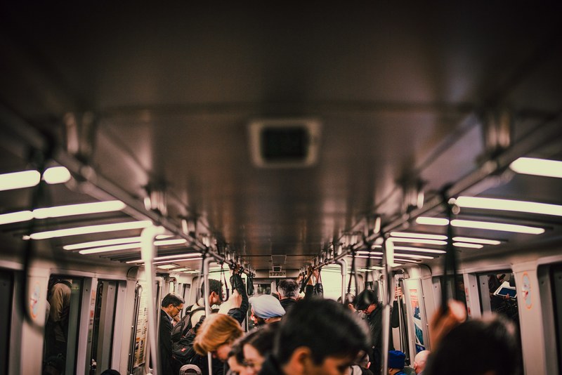 the interior of a crowded subway train, commute 4k