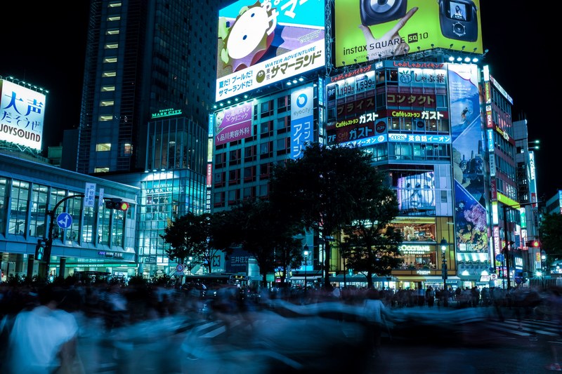 a crowd in a neon soaked street in tokyos shibuya district, crowd in tokyo 4k