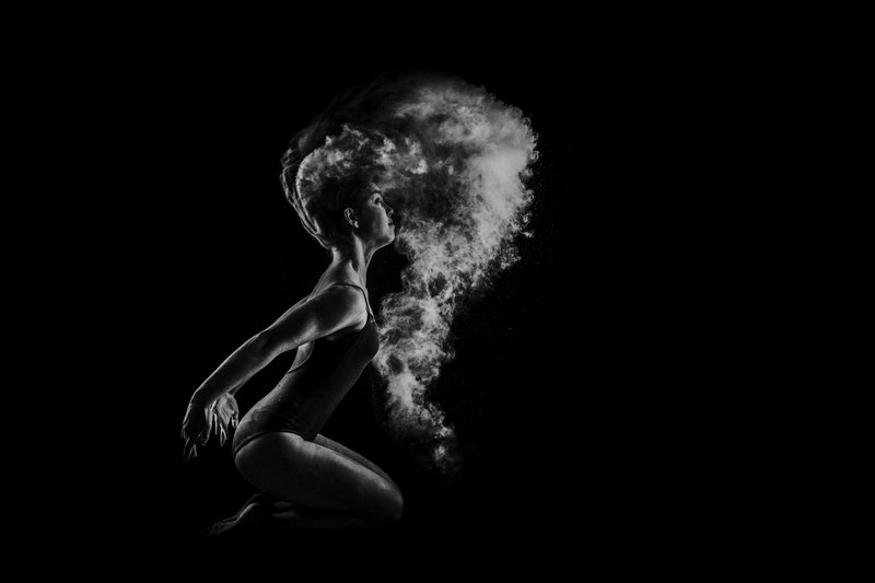 black and white shot of female dancer kneeling with powder flying in air matosinhos, ballet dancer and powder 4k