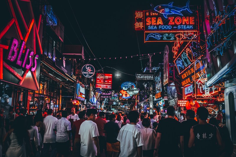 a street full of small shops and restaurants with bright led signs, _street shops 4k