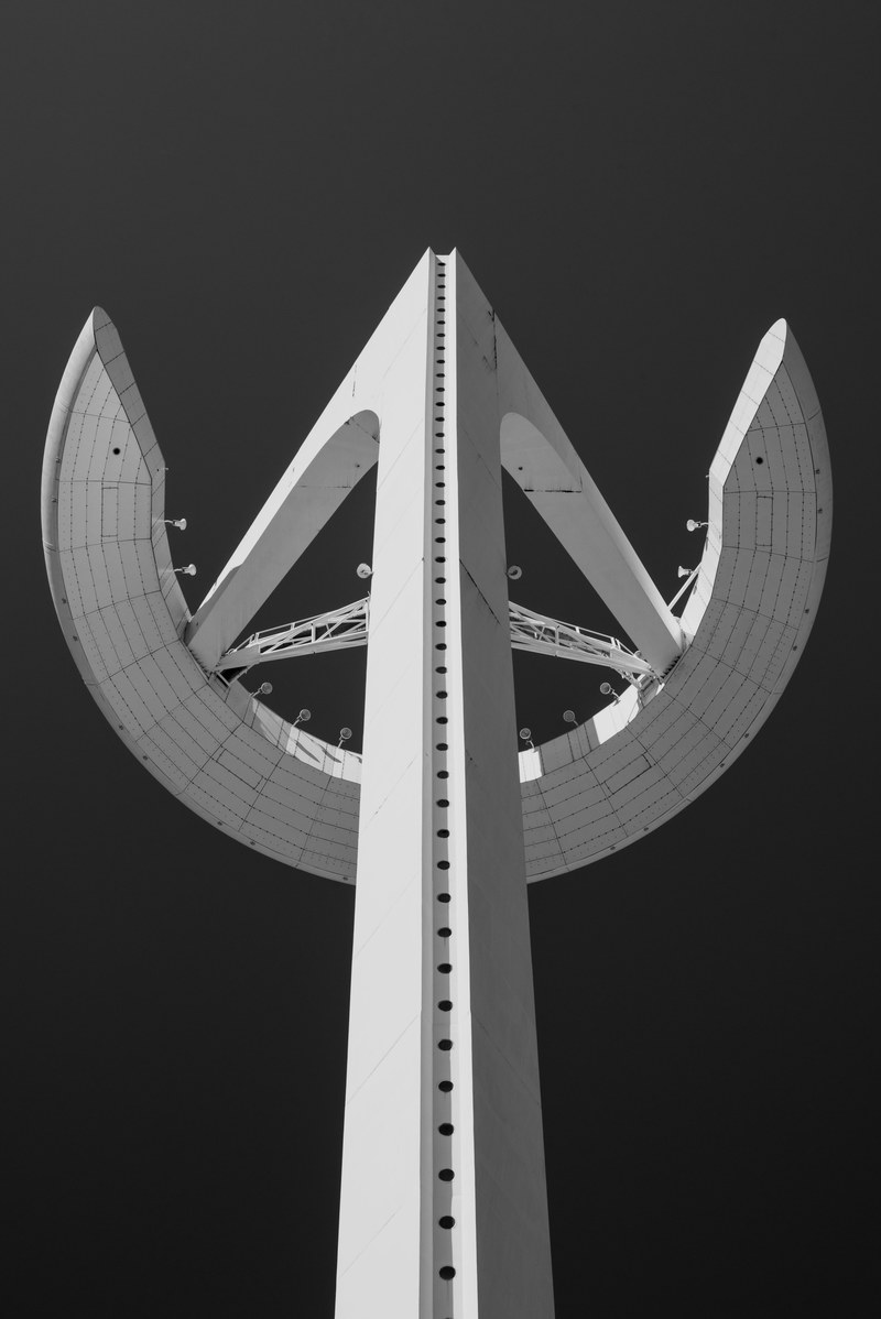 black and white shot of montjuc communications tower from below in barcelona, monochrome montjuc tower 4k