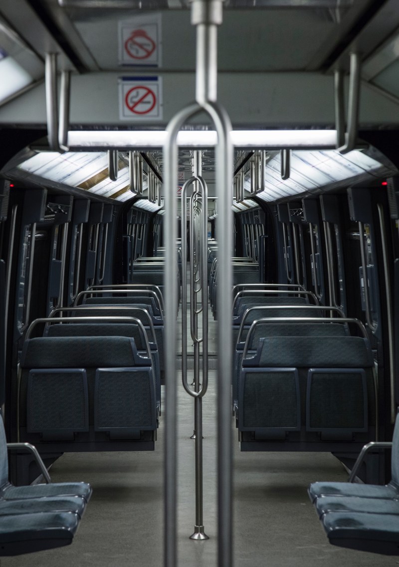 symmetrical view inside a city subway car with blue seats, empty subway train 4k