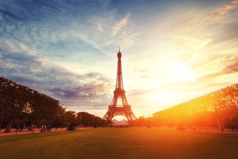 the eiffell tower with a blue sky light clouds and golden sunset with lens flare, _tower eiffel paris france 4k