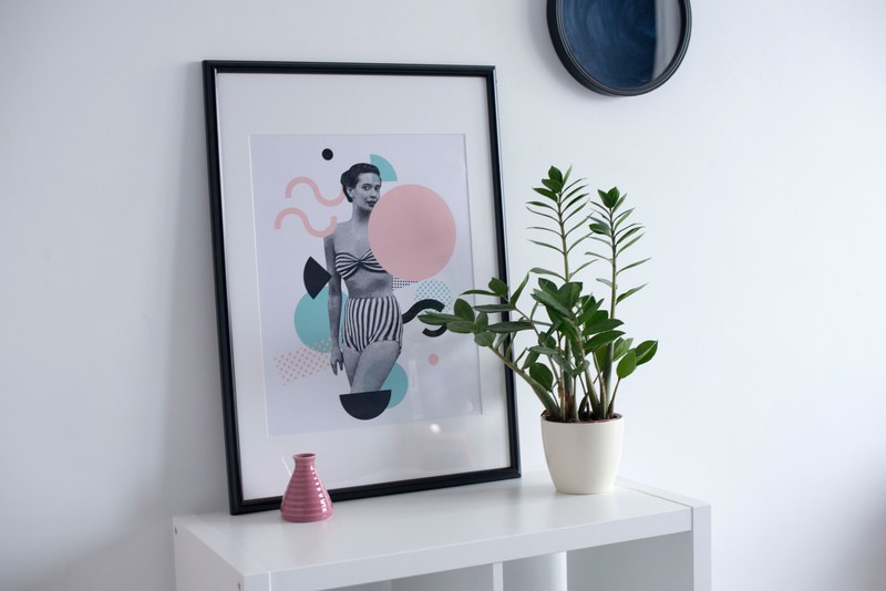 interior with framed portrait of woman and potted plant on white table, warsaw sunrise 2 4k