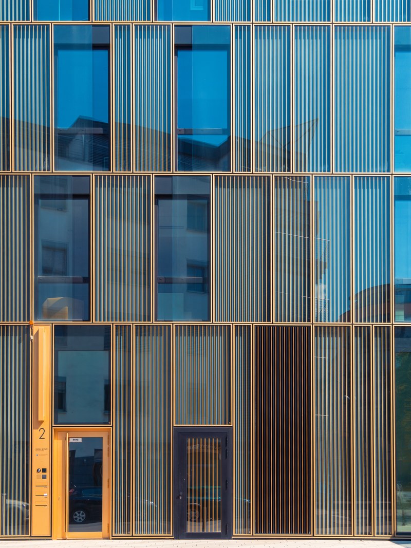 the entrance to a building with a modern facade with glass to ceiling windows in cologne, modern building entrance 4k