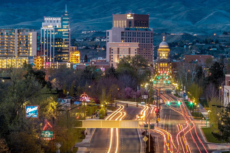 long shot time lapse of urban traffic and skyscrapers in boise at night, colorful urban traffic at night 4k