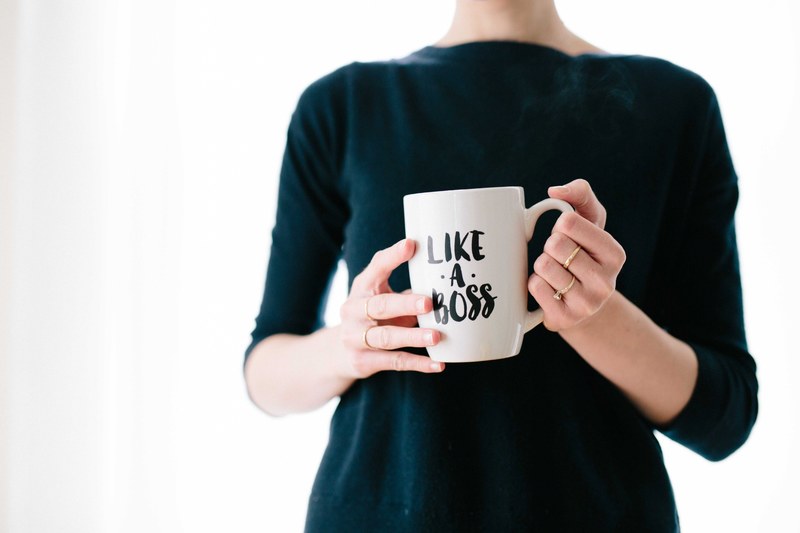 a woman holding a white mug with a like a boss print, like a boss 4k