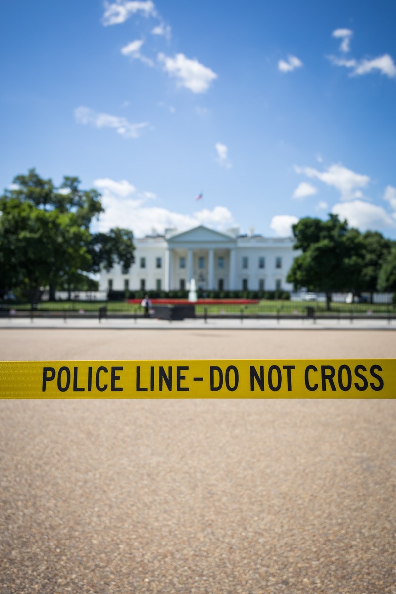 the white house in the usa taped off with police tape and a blue sky, crossing the line at the white house 4k