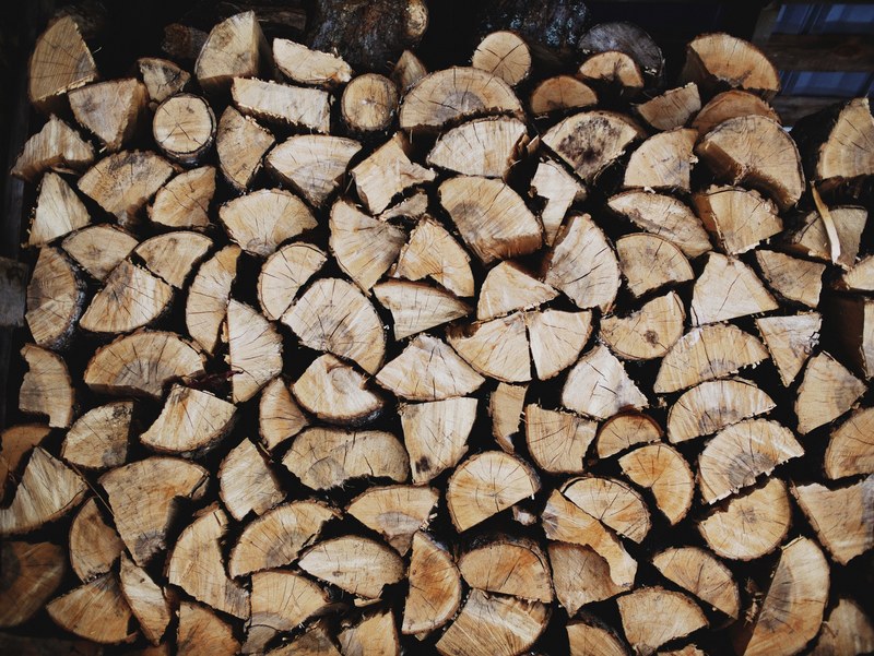 a stack of chopped firewood under a roof, wood pile in a shack 4k