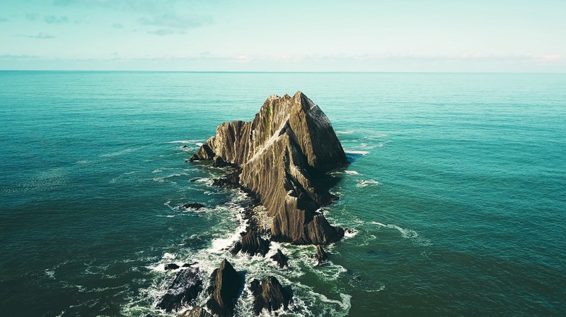 large rocks jutting out from the ocean, rock off of the california coast 4k
