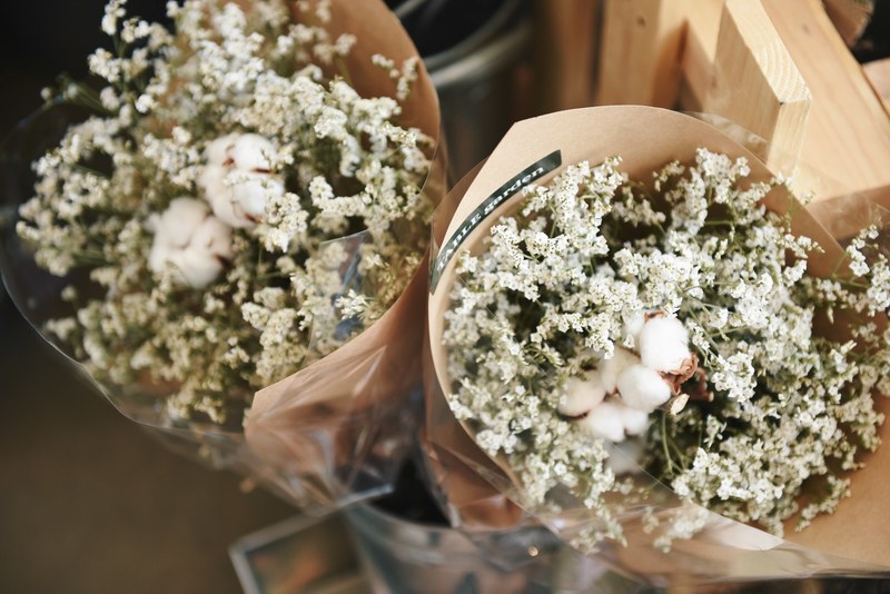 two large bouquets of babys breath flowers with cotton flowers in the middle wrapped in foil and paper, bouquet 4k