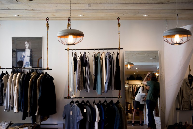racks with mens apparel on the walls of a clothes store, store organization 4k