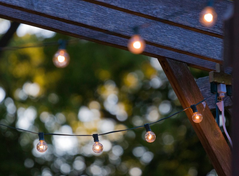 round light bulbs on a wire outdoors giving off warm light, friday night lights 4k
