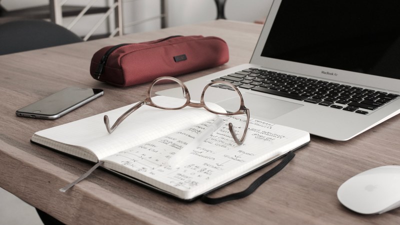 laptop and notebook with glasses on top of a wooden desk, laptop glasses notebook desk 4k
