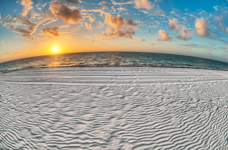 wind rippled white sand beachline at sunset, coastline at sunset 4k