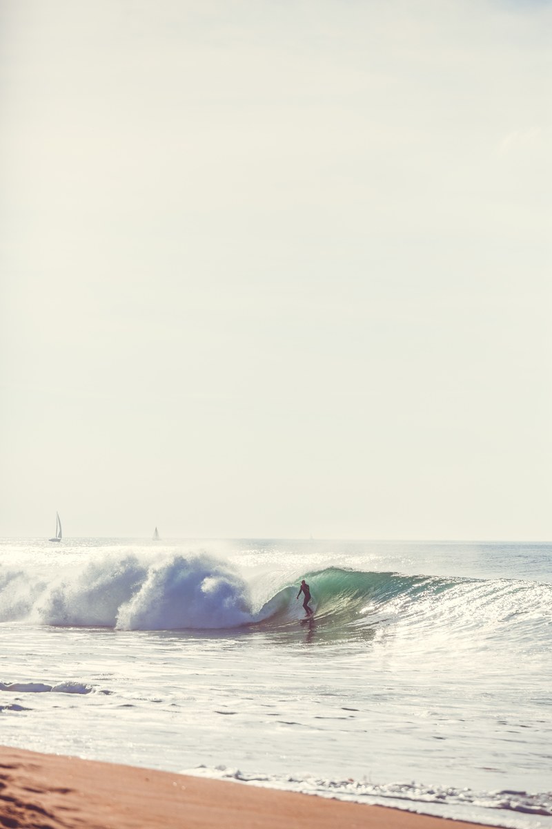 surfer surfing the wave near the beach at soorts hossegor, surfing with yachts 4k