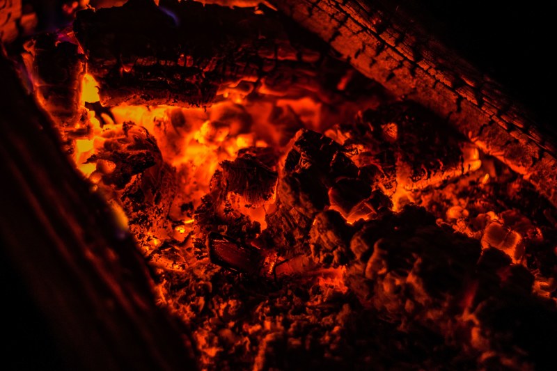glowing embers on hot logs in a fireplace, glowing embers 4k