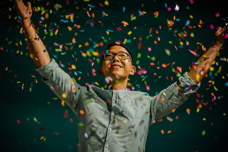 happy person celebrates their accomplishments with colorful confetti, confetti celebration 4k
