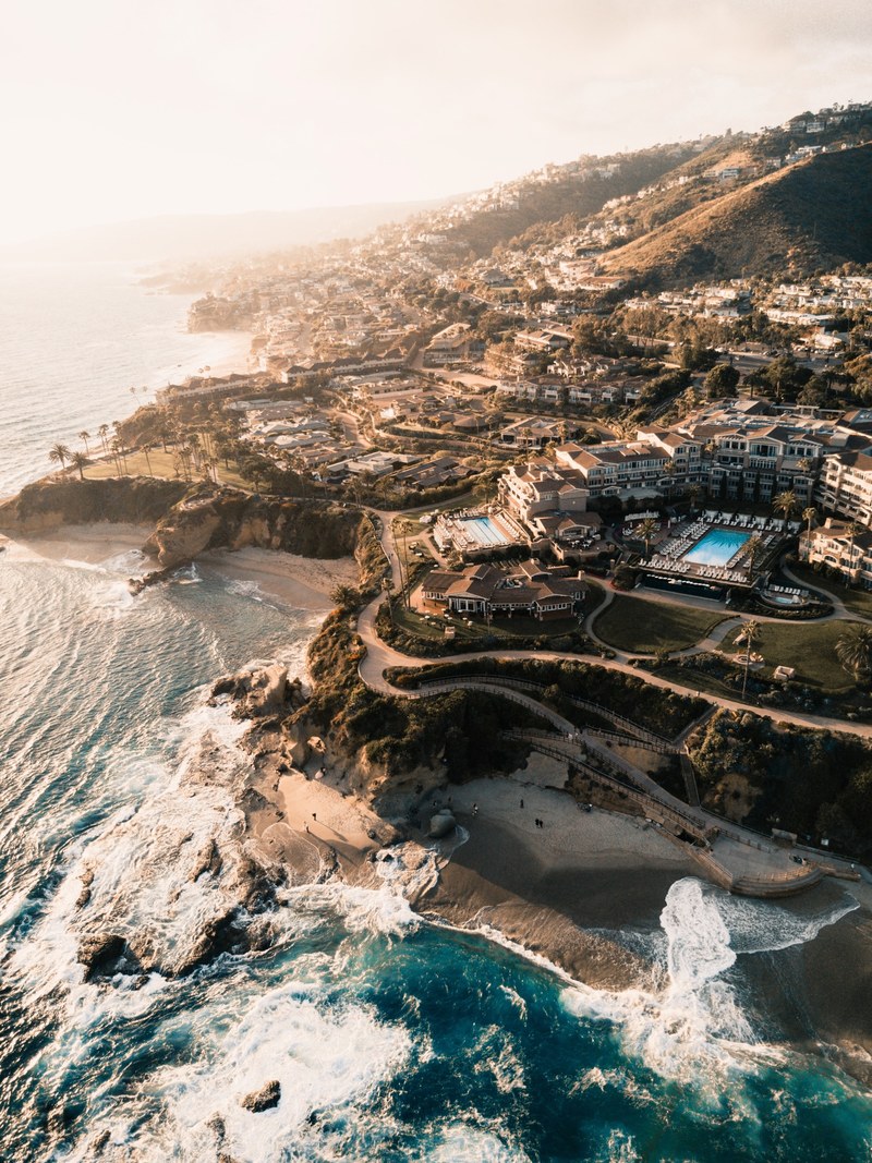 drone aerial view of the coastal beach resort at laguna beach, coastal resort 4k