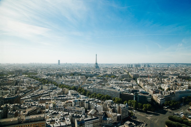 the skyline of paris with the eiffel tower against a blue sky, paris skyline view 4k