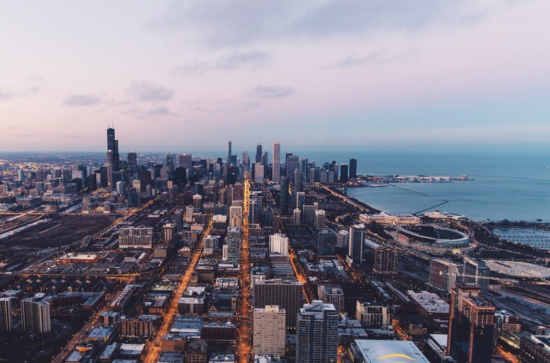 the skyline of chicago with a view on lake michigan on an evening, evening over chicago 4k