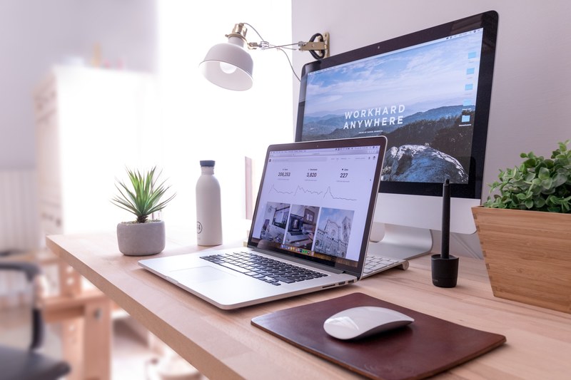 a macbook and an imac on a neat desk in a bright room, unsplash power 4k