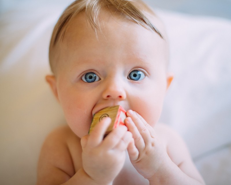 cute baby chewing on a letter block toy, baby toys 4k
