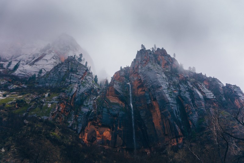 looking up at dark crags of mountains in zion national park, rain storm in zion 4k
