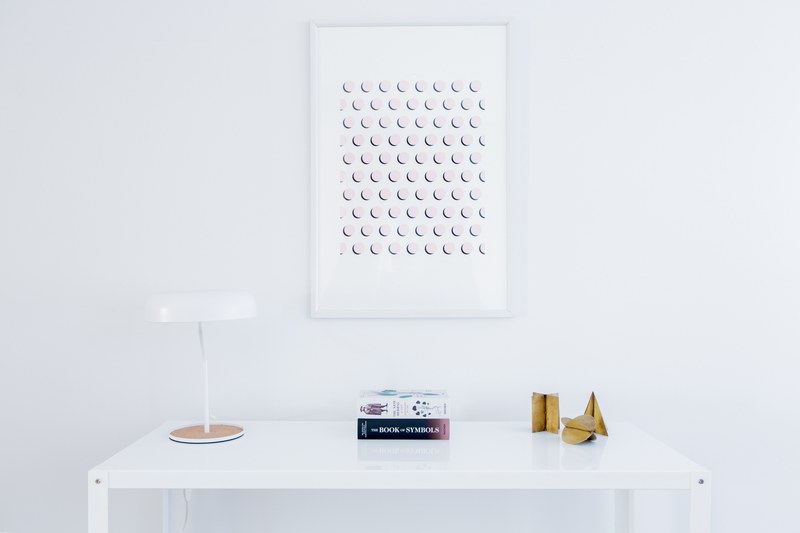 simple artwork hangs over clean white desk, minimal desk and painting 4k