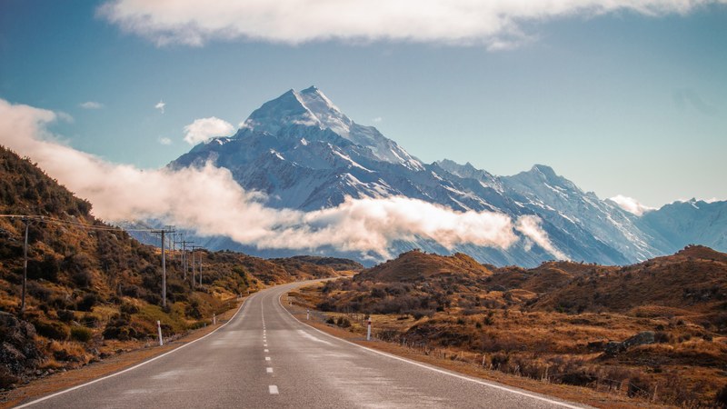 an empty bending road near the towering mount cook, road towards mount cook 4k
