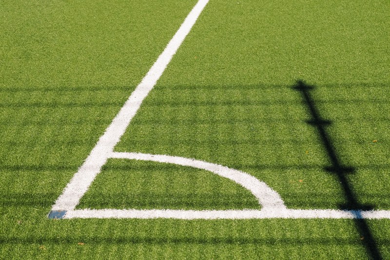 corner of soccer field with white lines in an angle on turf, soccer field turf corner 4k