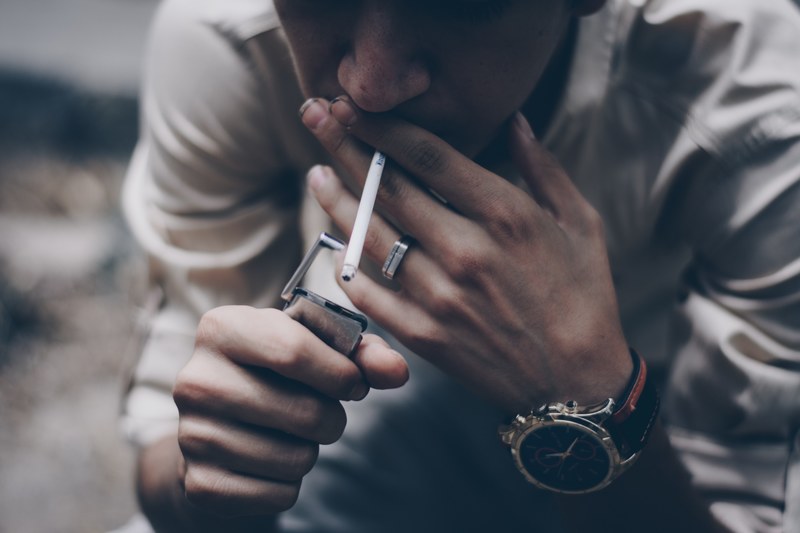 hand smoking lighter and cigarette 4k