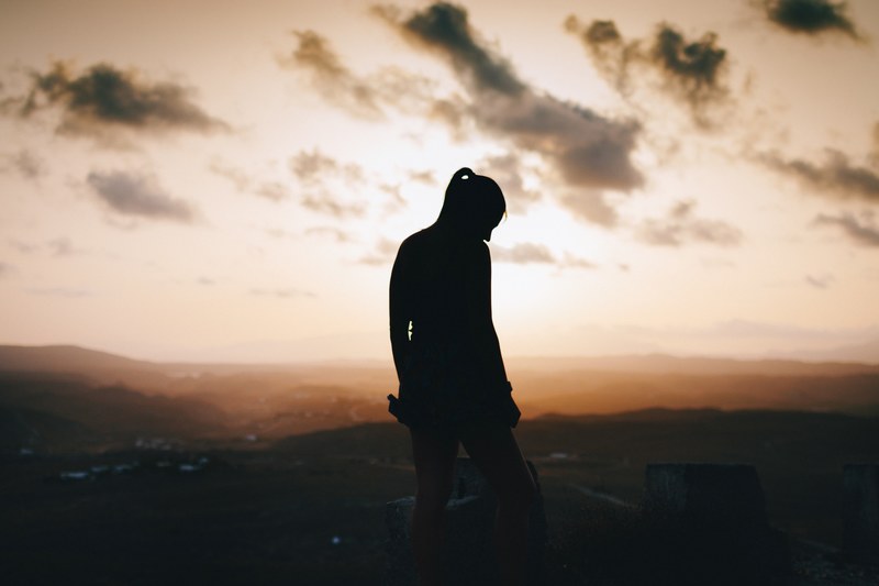 silhouette of a hiker atop a hill at sunset, all of us have a dark side 4k