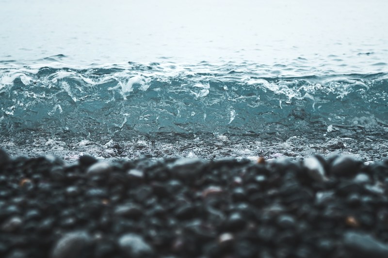 small wave washing on a pebble beach, wave washing on pebble beach 4k