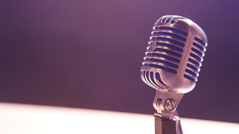 a microphone against a blurry background of white and black, late night 4k