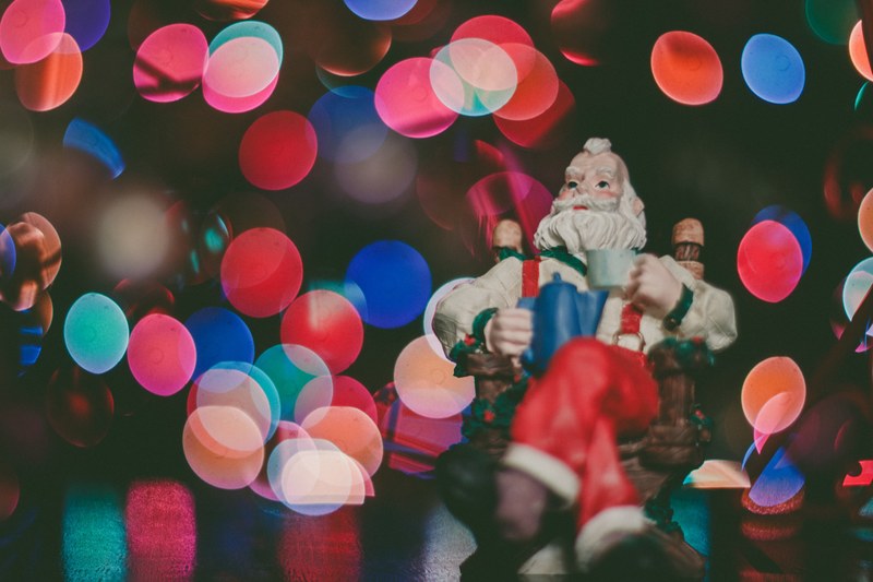 a santa claus statue with a bokeh in the background, a figure of christmas 4k