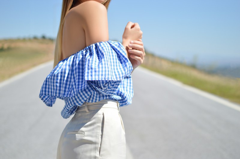 woman in a blue gingham shirt and dress slacks in the street, the perfect blue 4k