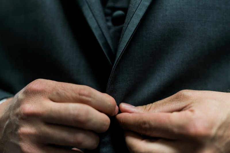 close up of a mans hands buttoning his black suit, suit amp button 4k