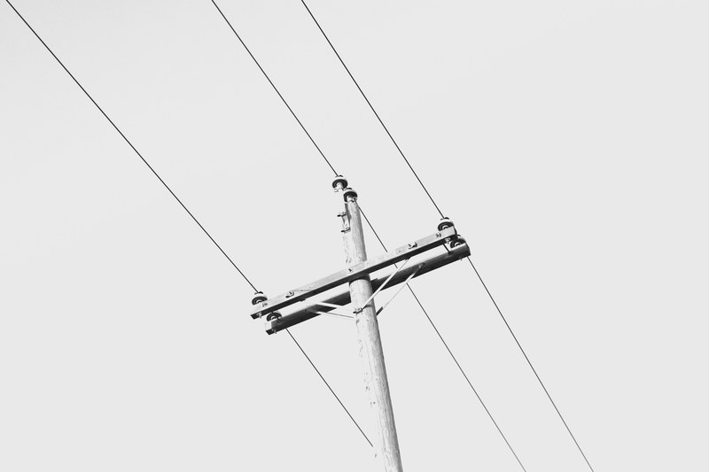 a black and white shot of a wooden power pole, wooden power pole 4k