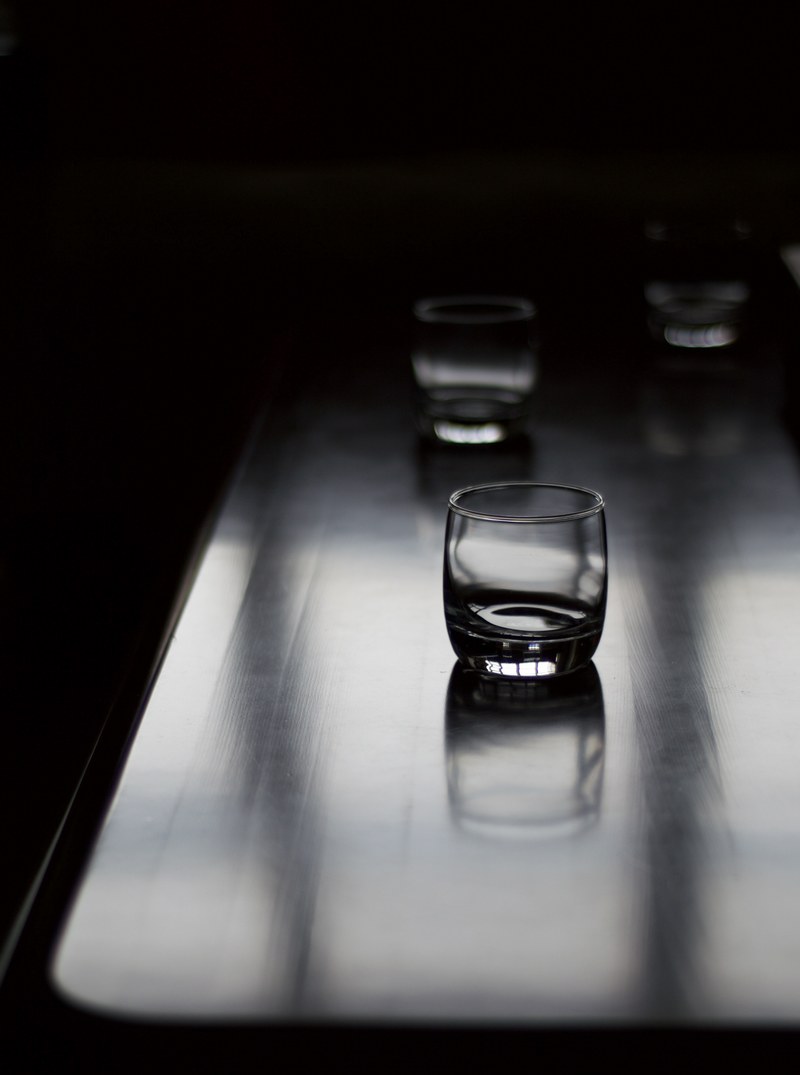 wooden table with three old fashioned glasses, glasses on table 4k