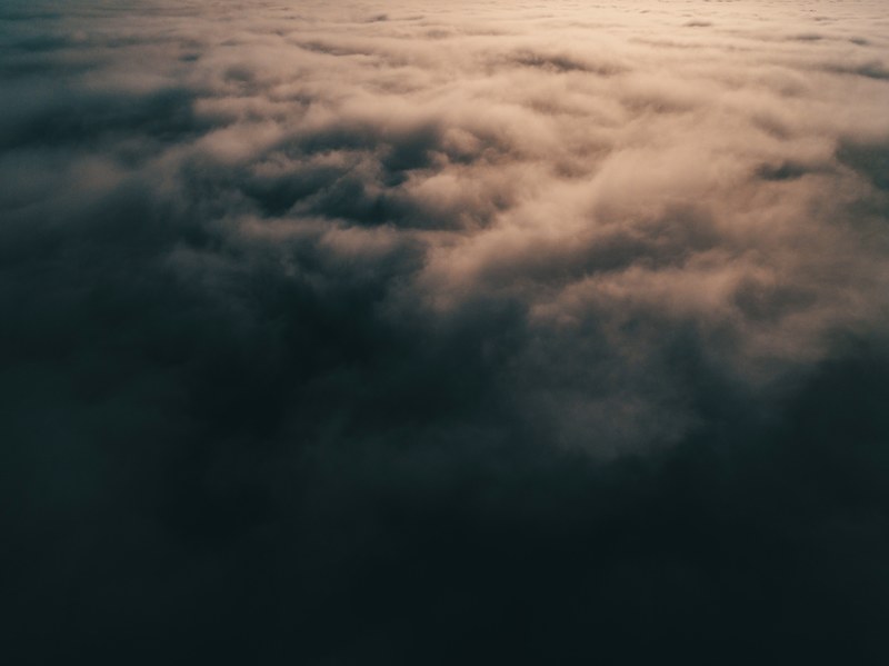 top of grey clouds with sunlight streaming on them, heaven and earth 4k