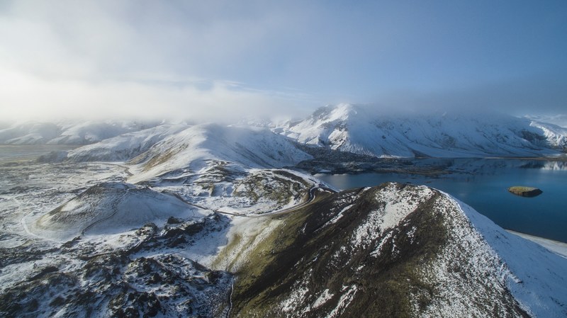 light haze over snowy hills near a lake in iceland, mountains amp volcano in iceland 4k